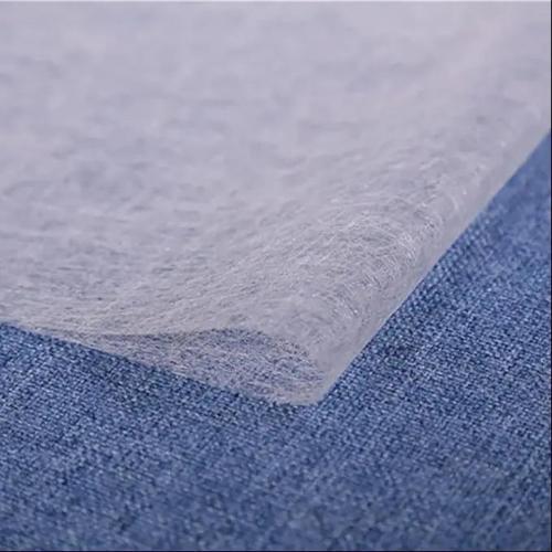 Close-up of interlining PV fusing fabric, used for bonding fabric layers and providing structure in garment manufacturing.
